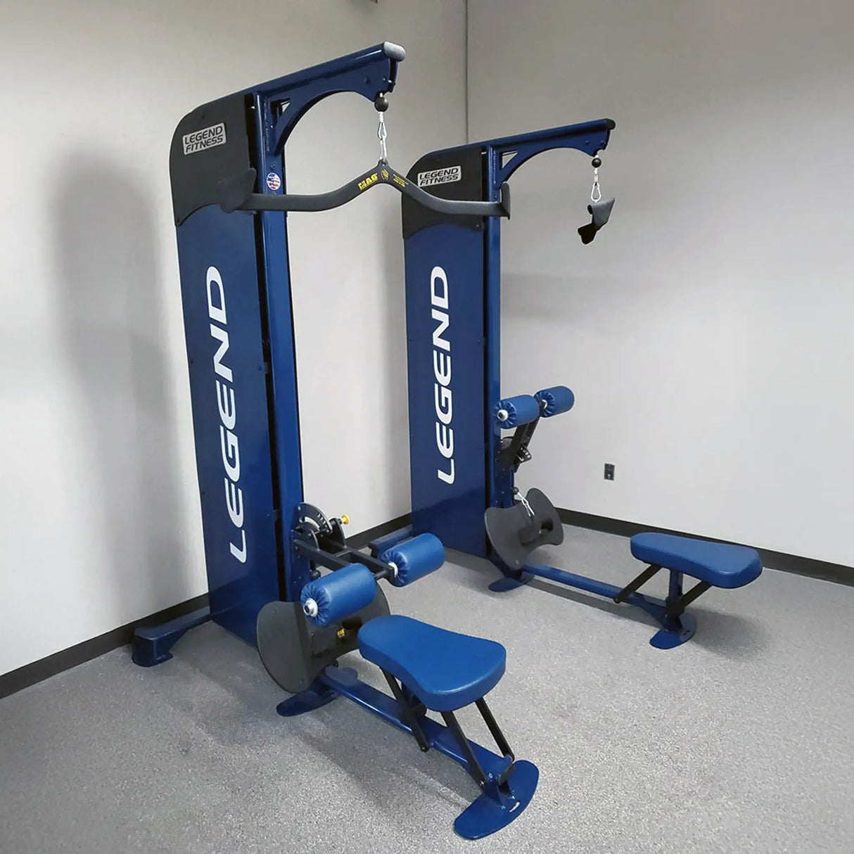 Two blue Legend Fitness machines in a gym setting