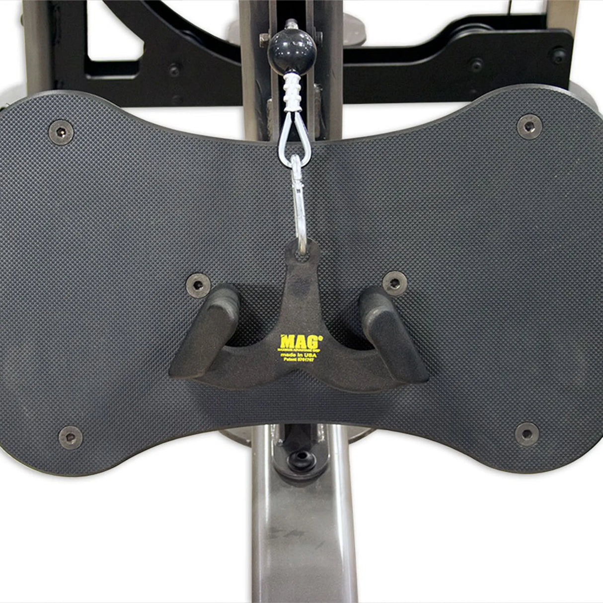 Black UHMW footplate on a gym machine with a MAG brand handleleaning against it