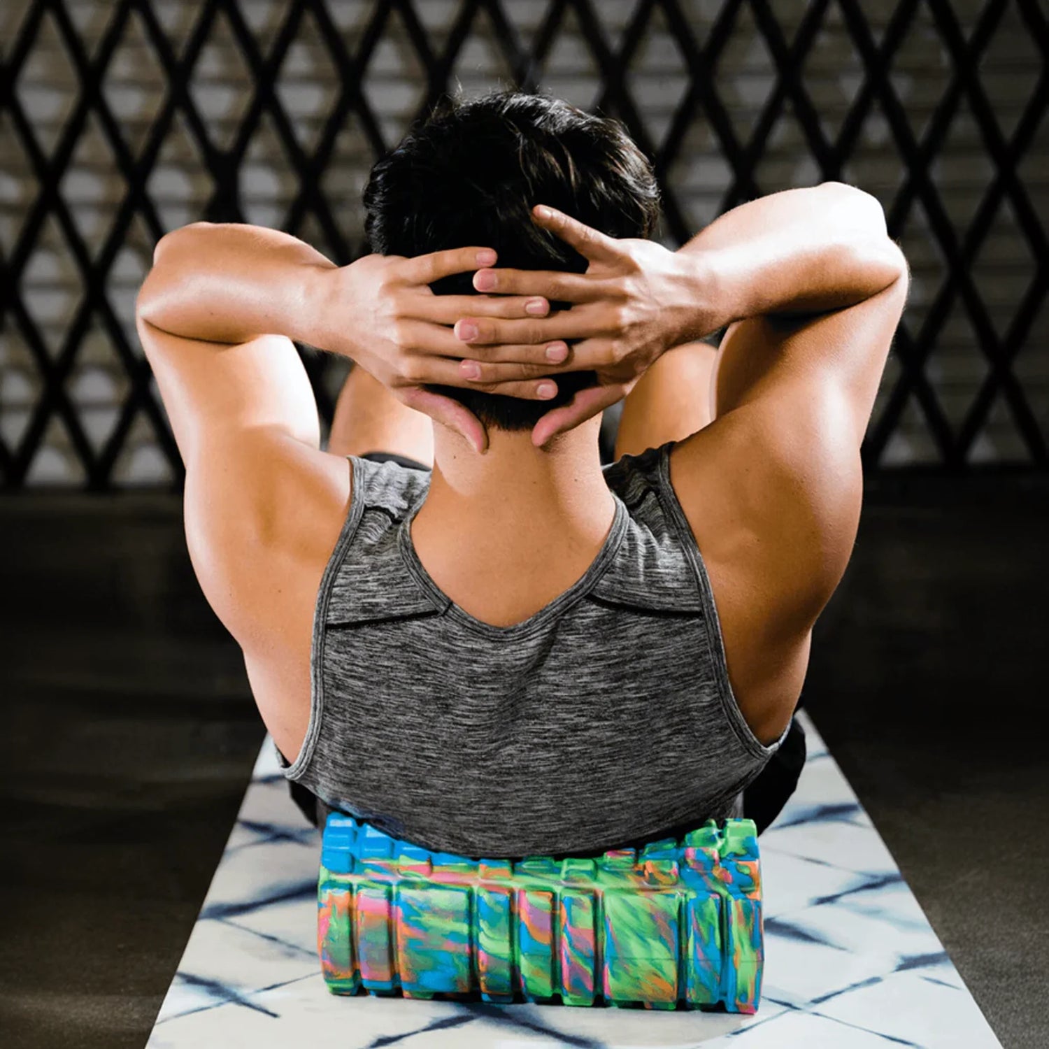 Man rolling on multi-color tie dye short foam roller