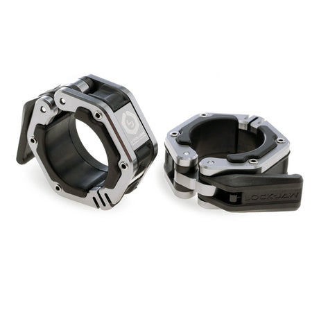 A pair of black and silver Lock-Jaw metal barbell collars with visible branding and magnets on the inside.