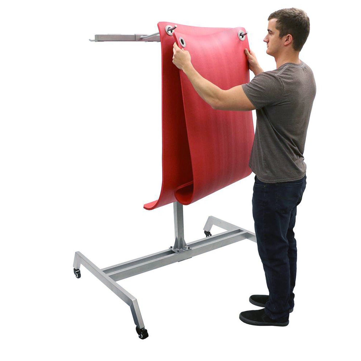 Mobile exercise mat storage rack with wheels with man hanging mats on it