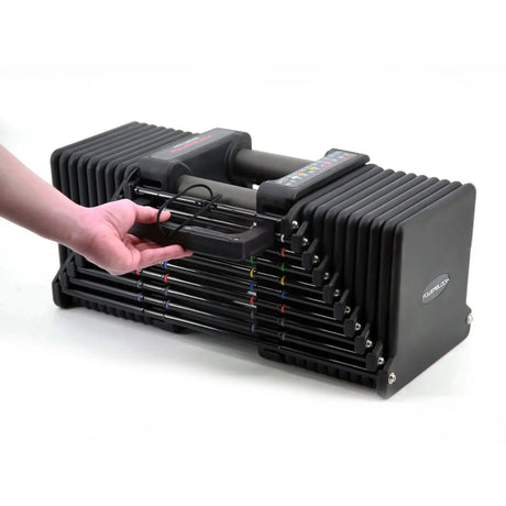A PowerBlock Commercial Pro 175 Dumbbell with a man pulling out the side pin
