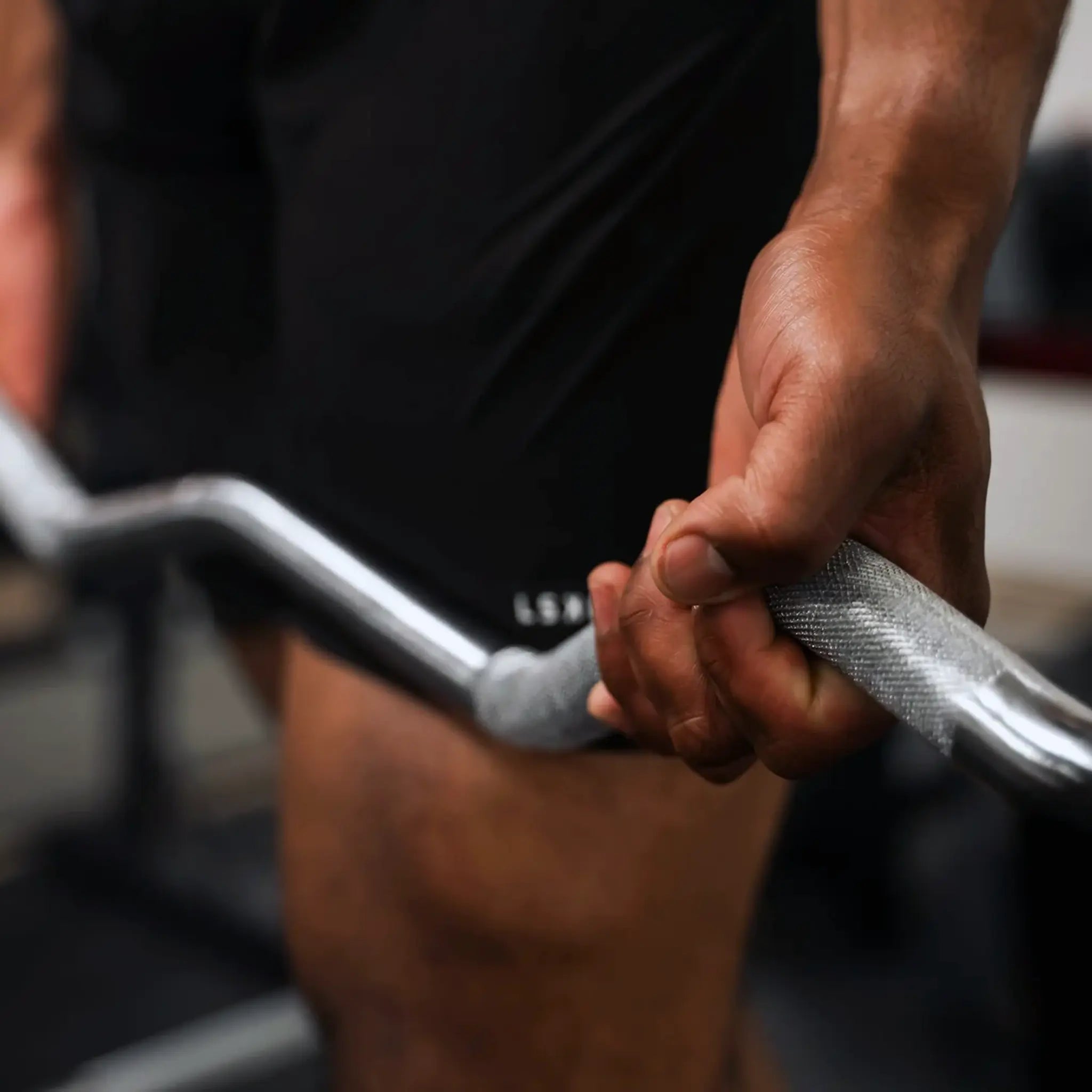 Man holding a PowerBlock EZ barbell