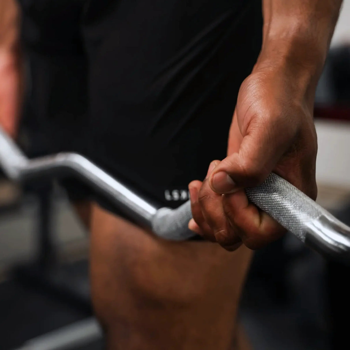 Man holding a PowerBlock EZ barbell