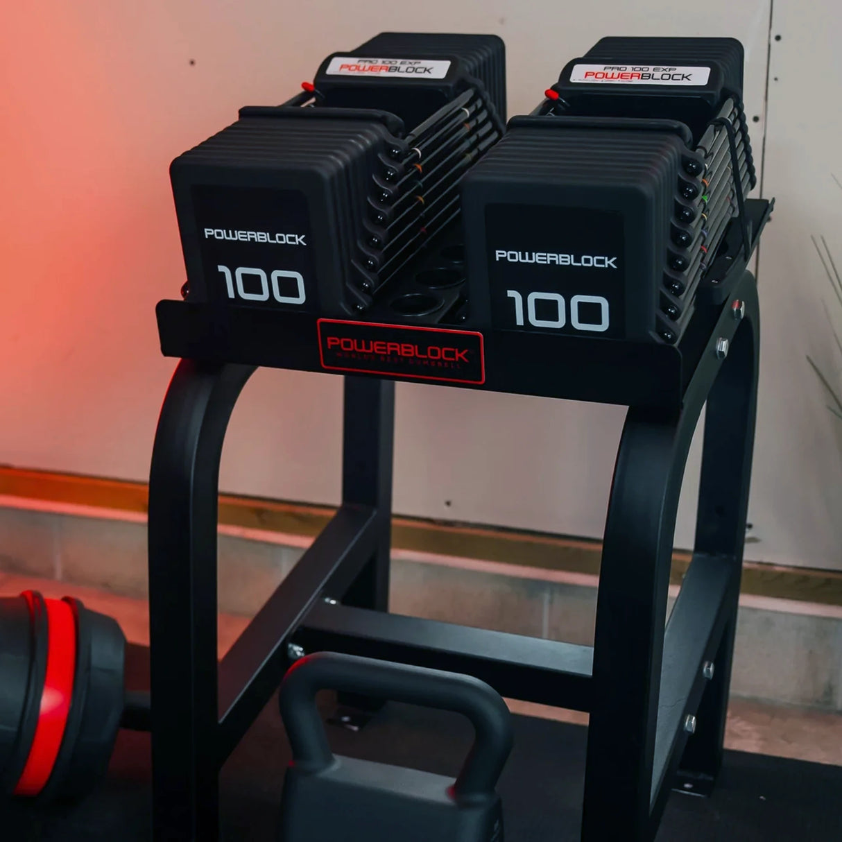 A PowerBlock Home Rack Stand with dumbbells on it