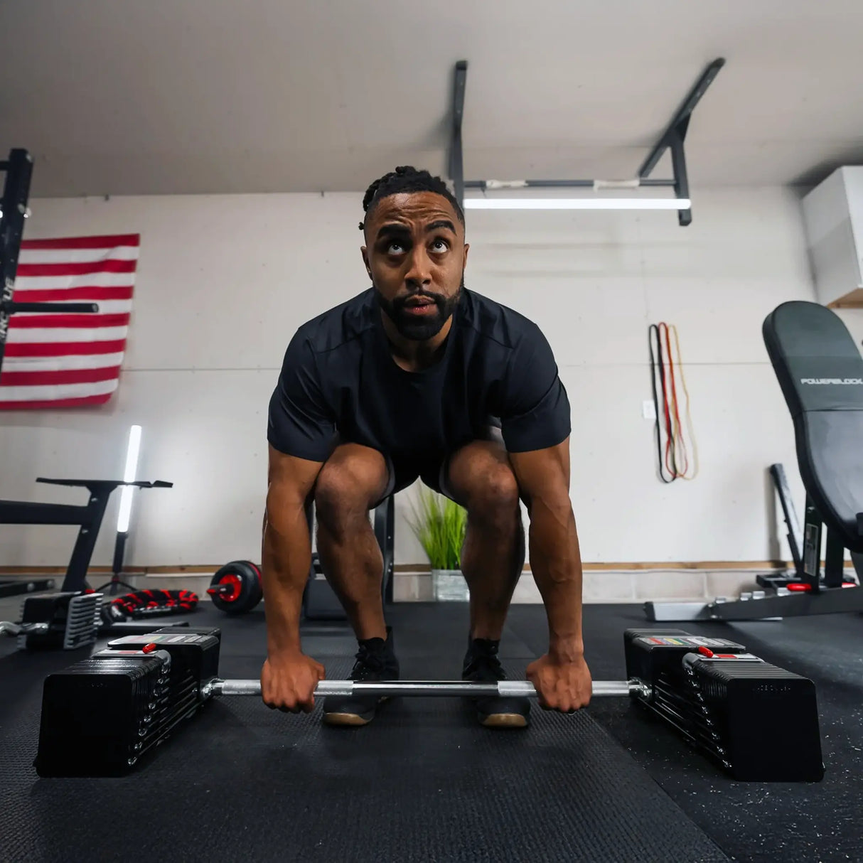 Man deadlifting a PowerBlock straight barbell