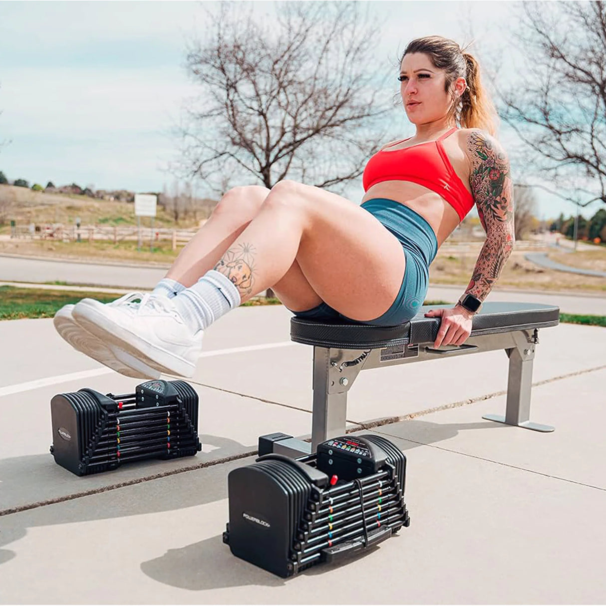 A woman doing core work on a PowerBlock Fold Up Portable Travel Bench