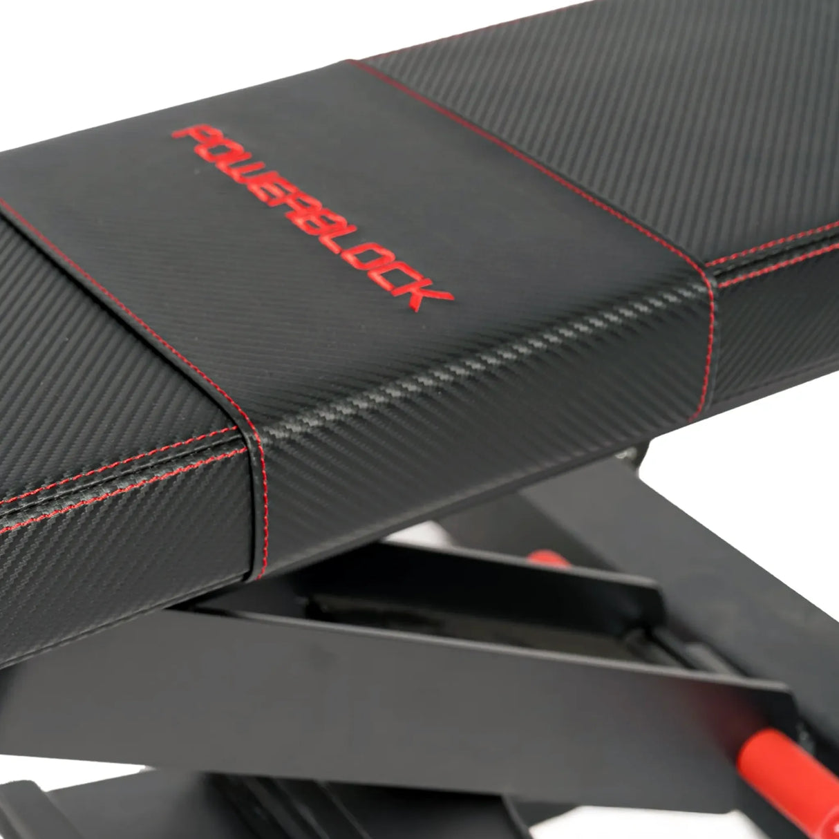 A closeup image of the back pad on a black PowerBlock utility bench