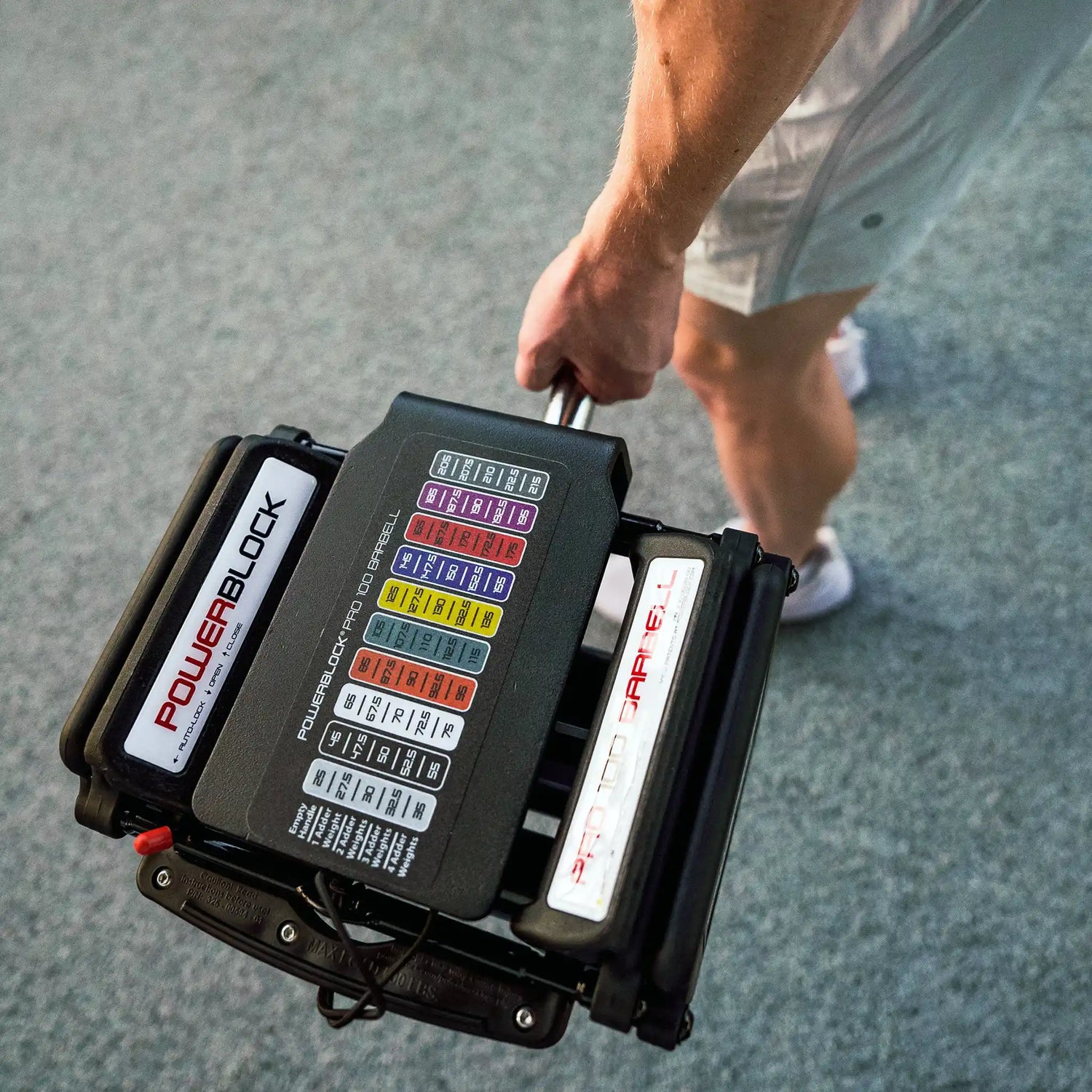 Man holding a PowerBlock EZ barbell