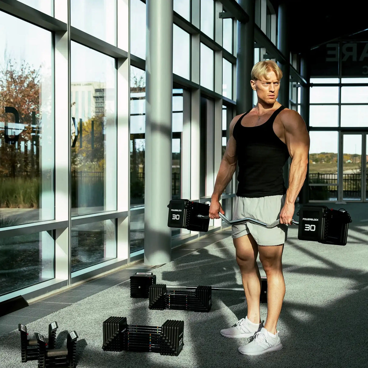 Man holding a PowerBlock EZ barbell
