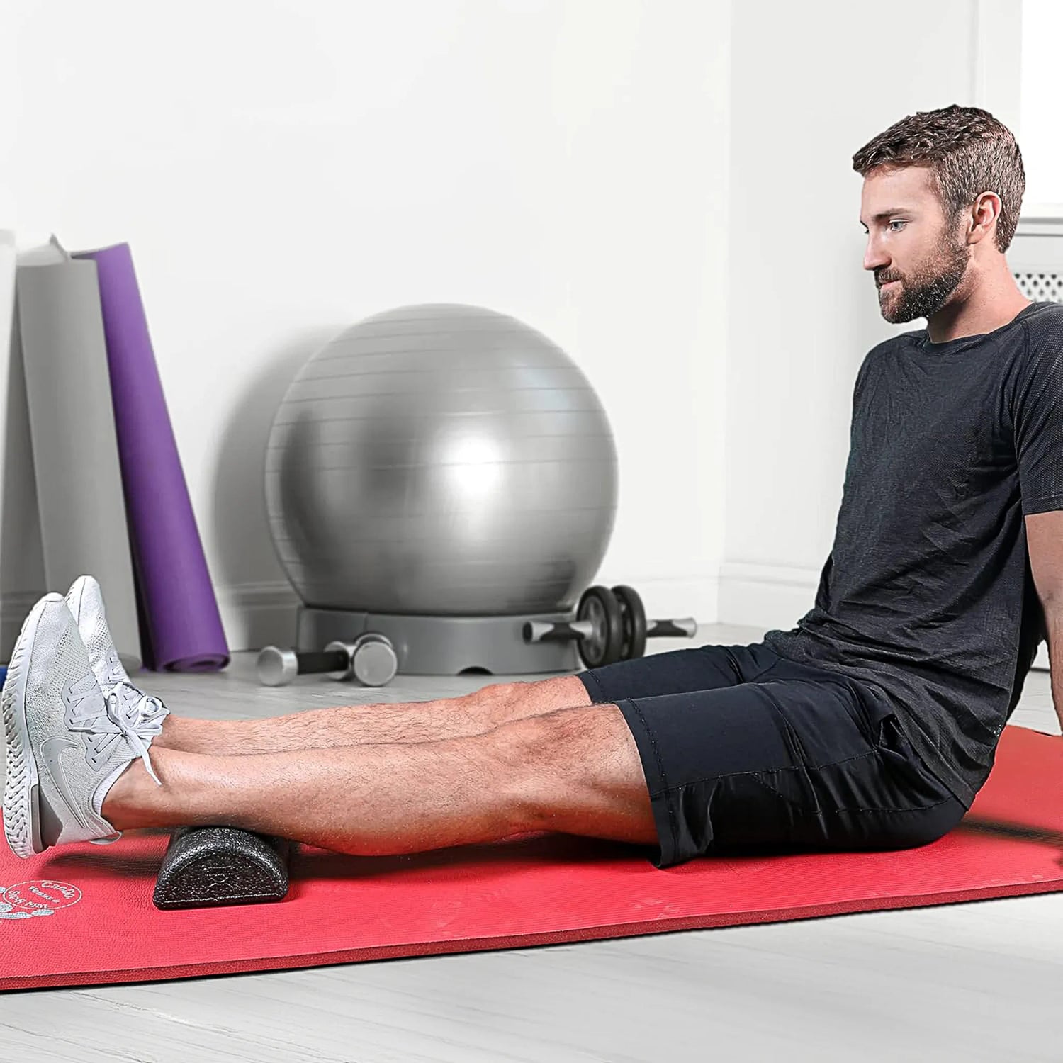 Man rolling calves on high density short semi circle foam roller by CanDo