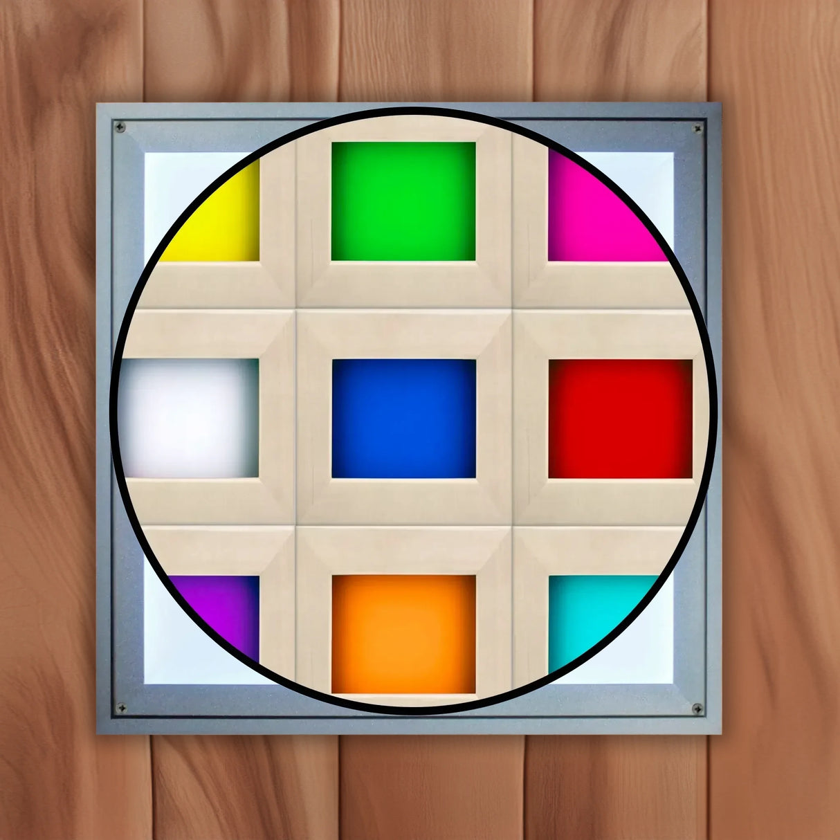 The white cover on a chromotherapy lighting system found inside of a Canadian red cedar sauna with a cutout which shows the nine colors the light can display including yellow, green, pink, dark blue, white, red, orange, light blue, and purple