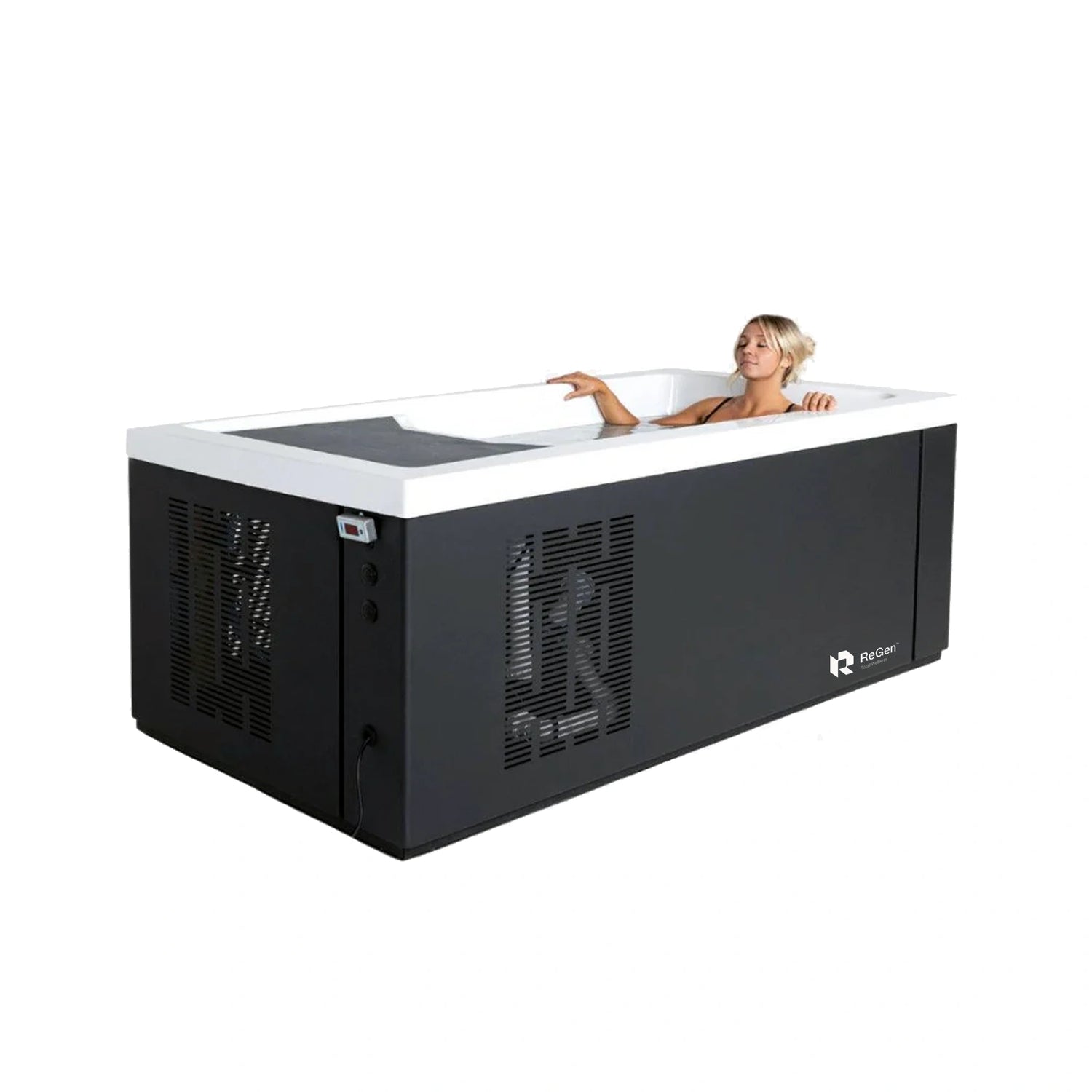 A rectangular cold plunge with a black exterior and white acrylic interior with an attractive blond woman in a black bikini laying down inside the tub with her eyes closed.