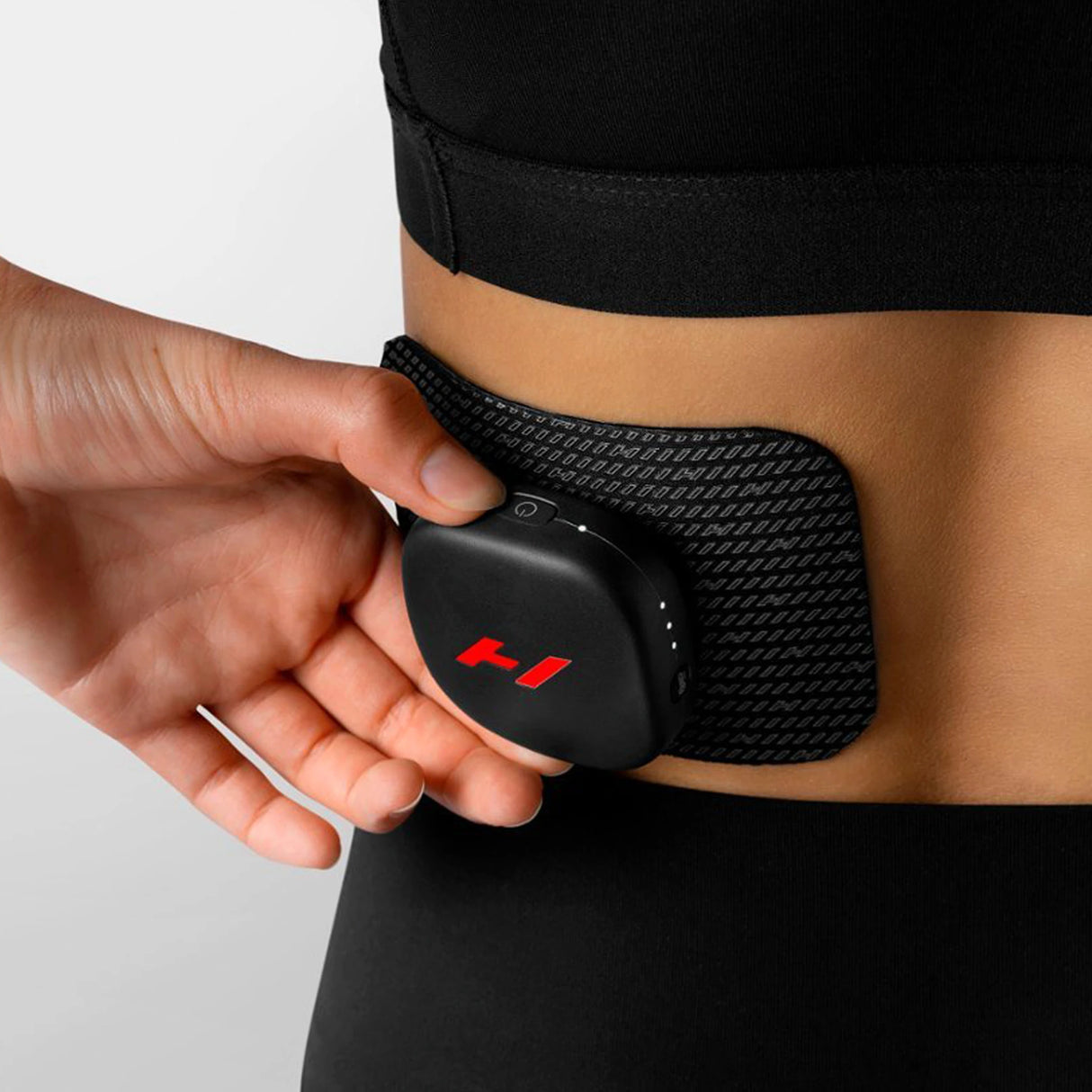 Heat and vibration therapy device which magnetizes to a pad which you stick to your body to help alleviate muscle soreness and speed up recovery