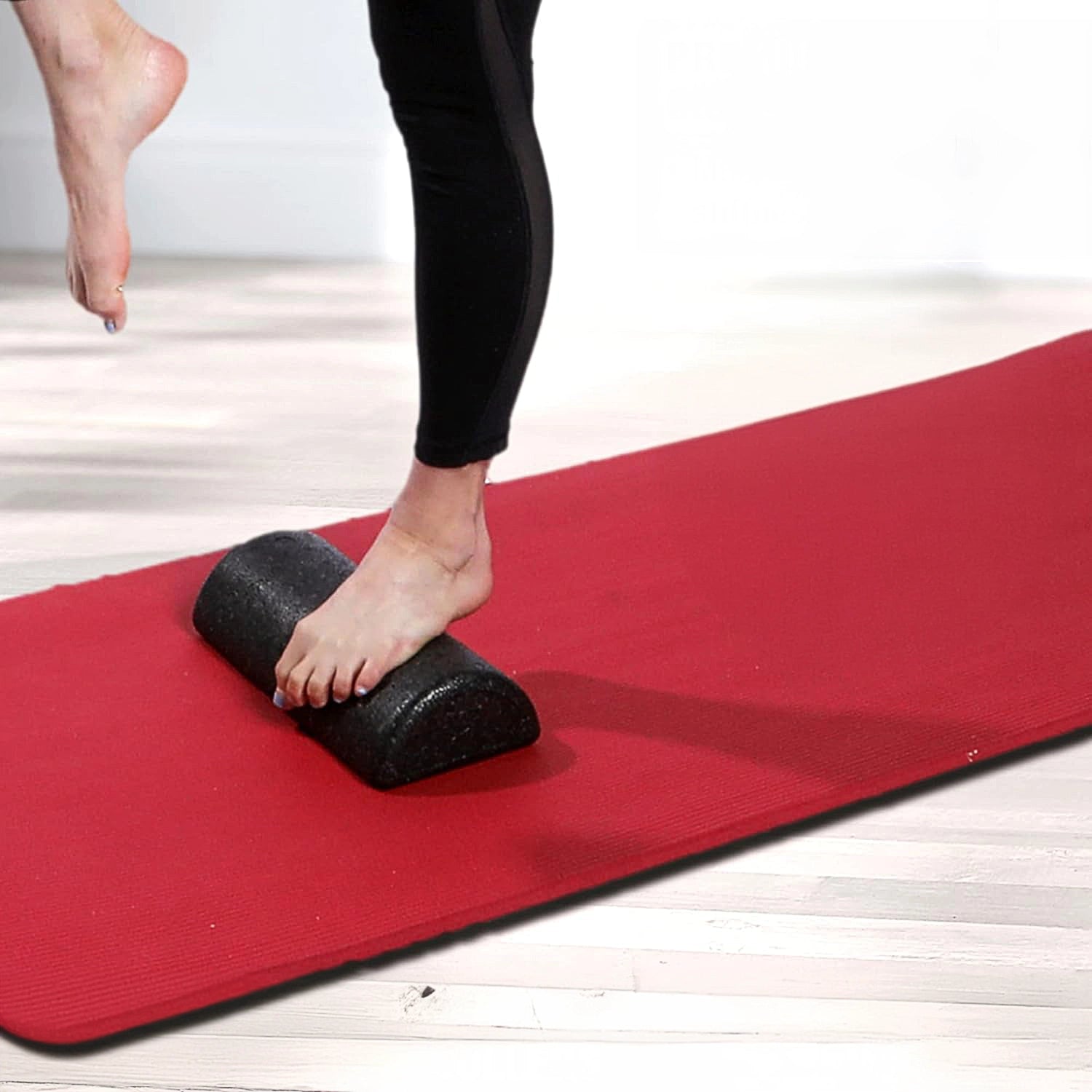 Woman balancing on high density short semi circle foam roller by CanDo