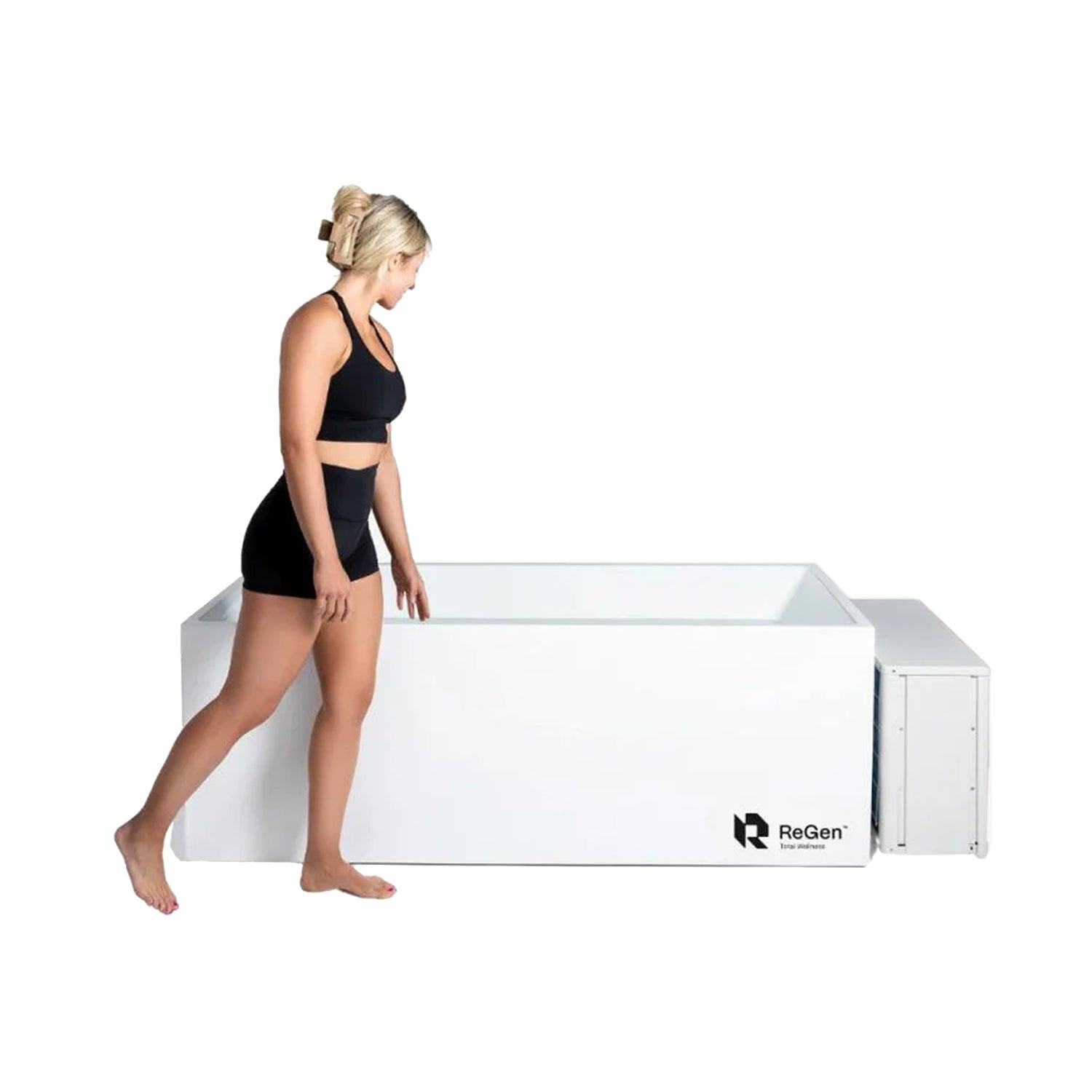 A white rectangular cold plunge with an external chiller and a woman standing next to it