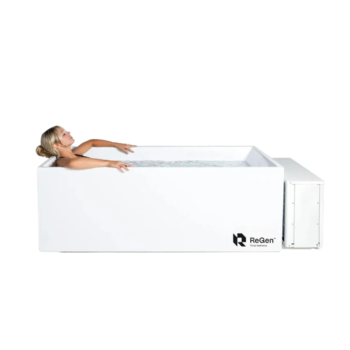 A white rectangular cold plunge with an external chiller and a woman lying inside it