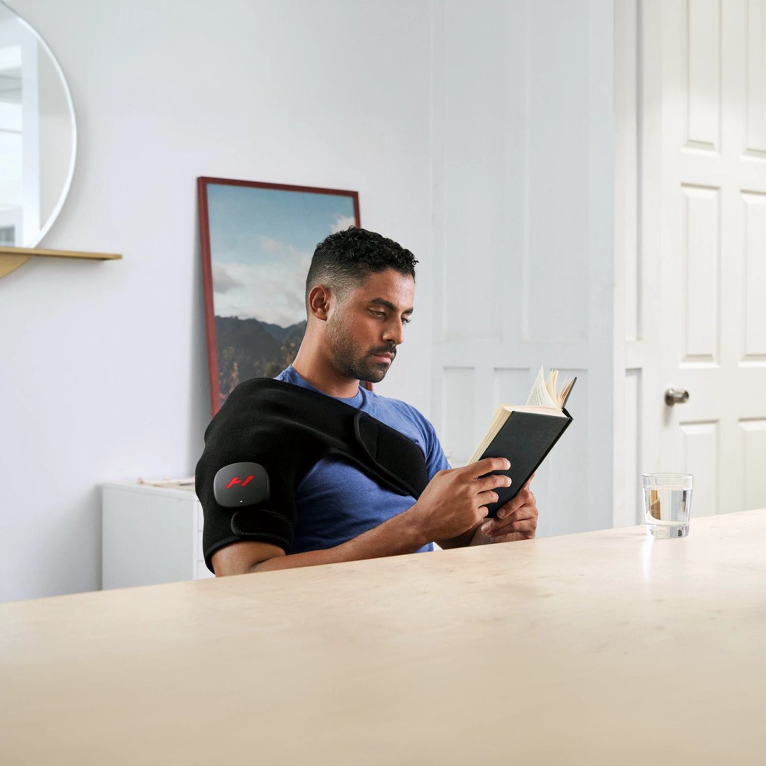 Pad which wraps around your shoulder to provide heat and vibration therapy to increase circulation and decrease pain