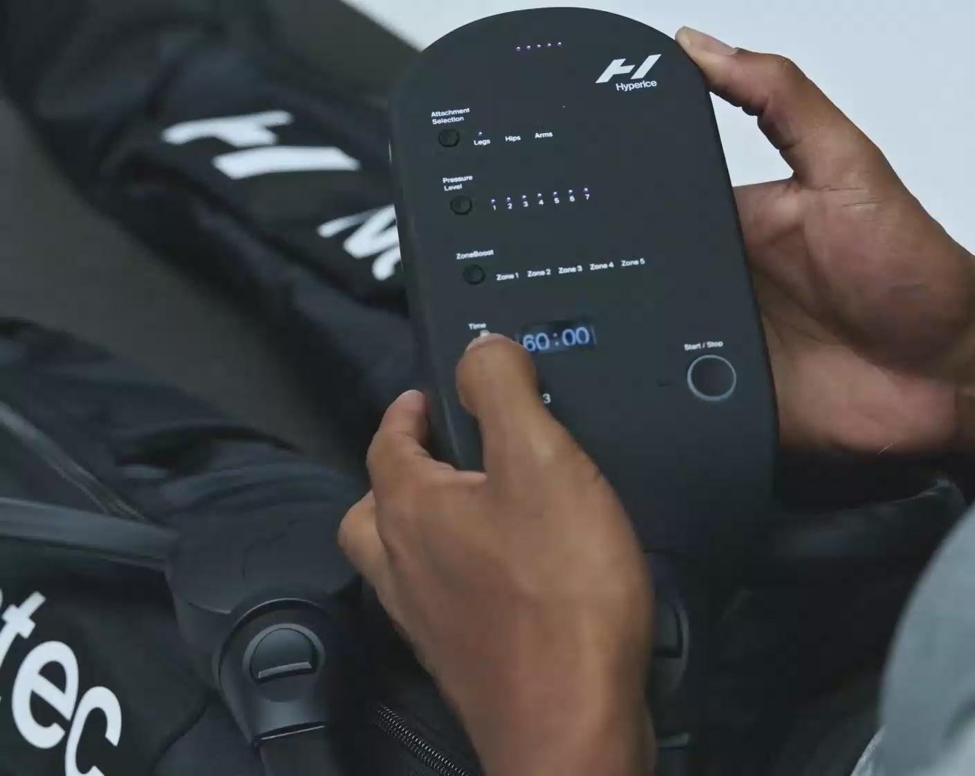 A video showing a man operating the control unit for a Normatec 3 control unit.