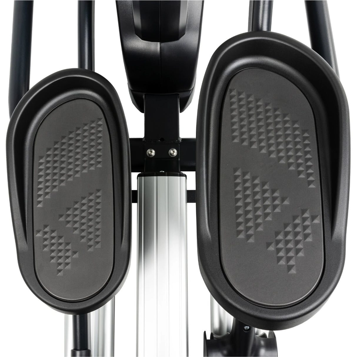 Close-up view of two textured black foot pedals on the Spirit Fitness CE800 Elliptical by Spirit Fitness, highlighting the patterned non-slip surfaces and a portion of the silver central frame below.
