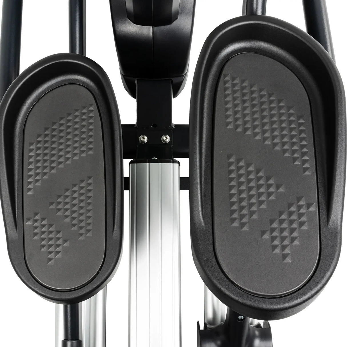 Close-up of two textured black foot pedals on the Spirit Fitness CE800ENT Elliptical by Spirit Fitness, featuring a metal bar and support structure between them.