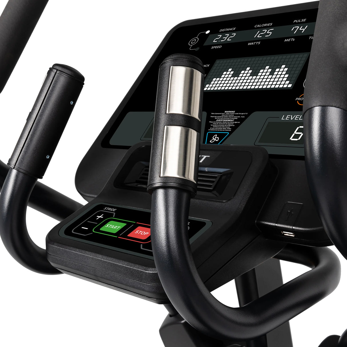 Close-up of the Spirit Fitness CE850 Elliptical's digital display showing fitness metrics like speed, calories, and pulse. Spirit Fitness handlebars with metallic heart rate sensors are visible in the foreground.