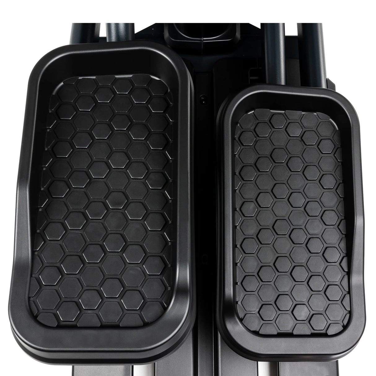 The Spirit Fitness CE900 Elliptical by Spirit Fitness features black pedals with a hexagonal grip pattern.