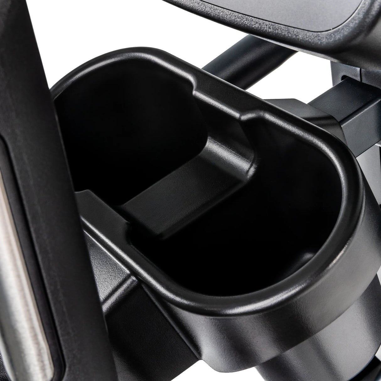 Close-up of a black plastic dual cup holder attached to the metal frame of a Spirit Fitness CE900 Elliptical by Spirit Fitness, featuring an empty, smooth interior.