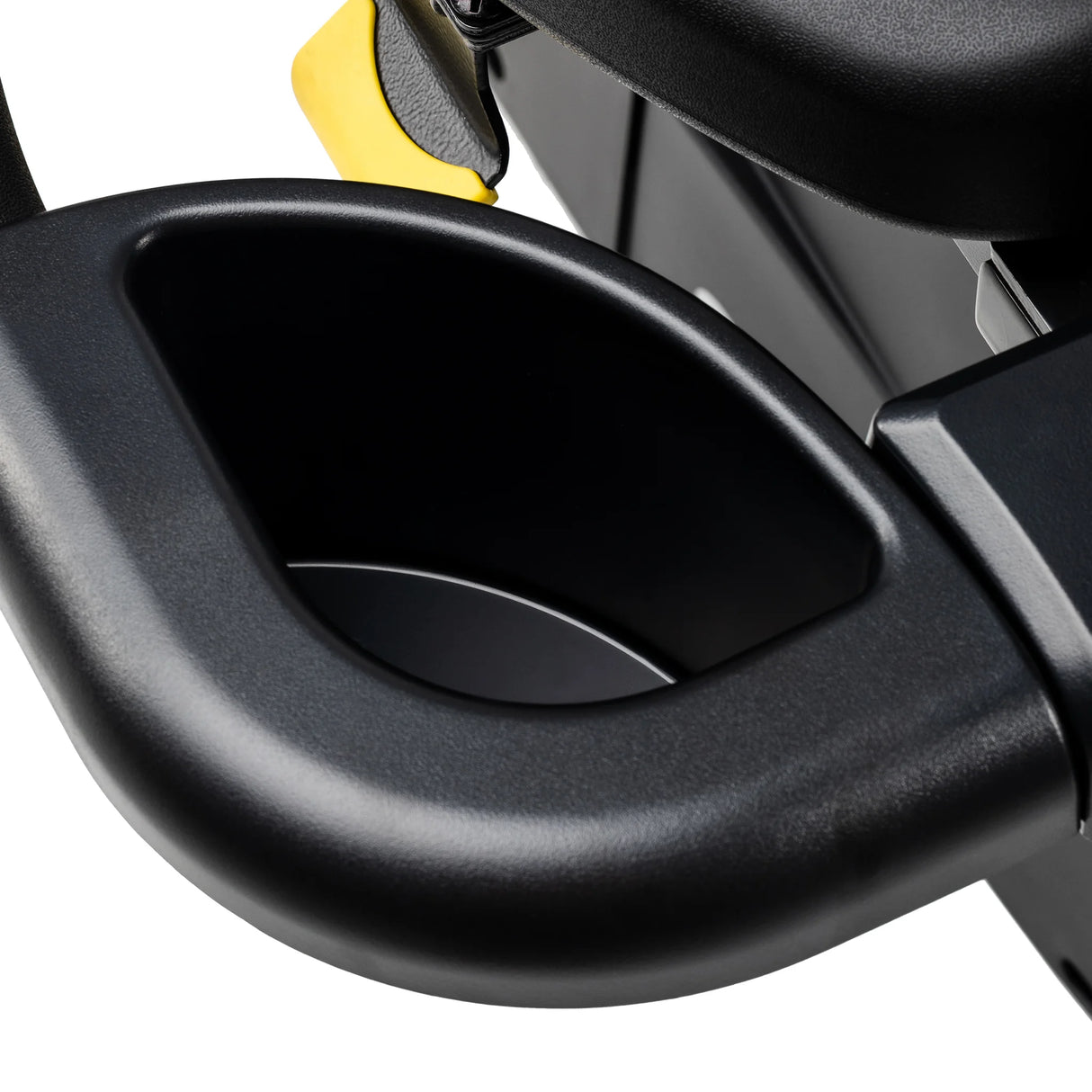 Close-up of the Spirit Fitness CR1000ENT Recumbent Bike's molded cup holder and accessory tray built into the armrest, with the yellow seat-recline release lever visible behind it.