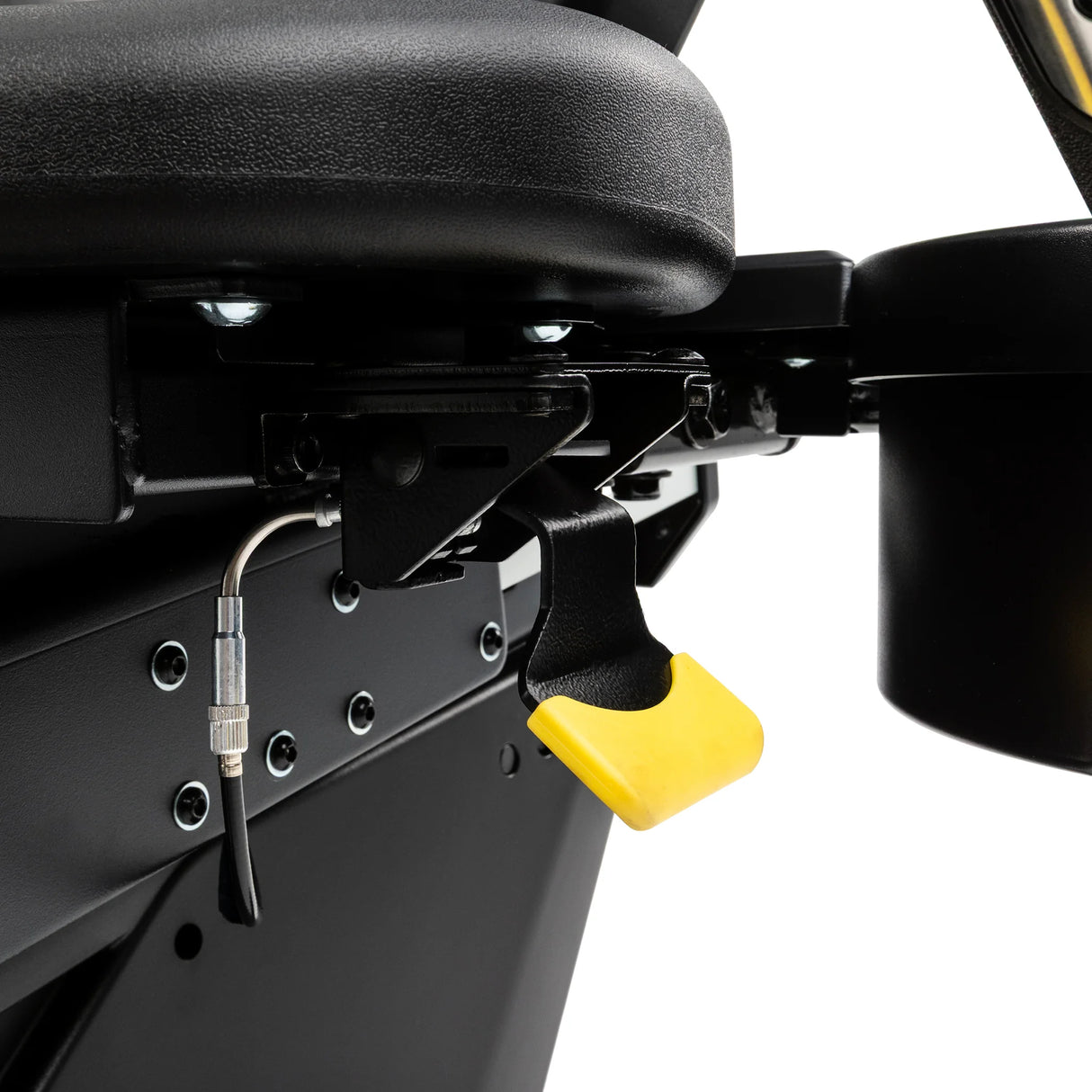 Close-up of the Spirit Fitness CR1000ENT Recumbent Bike's seat adjustment mechanism, showing the yellow release lever and mounting hardware beneath the seat used to slide it along the rail.