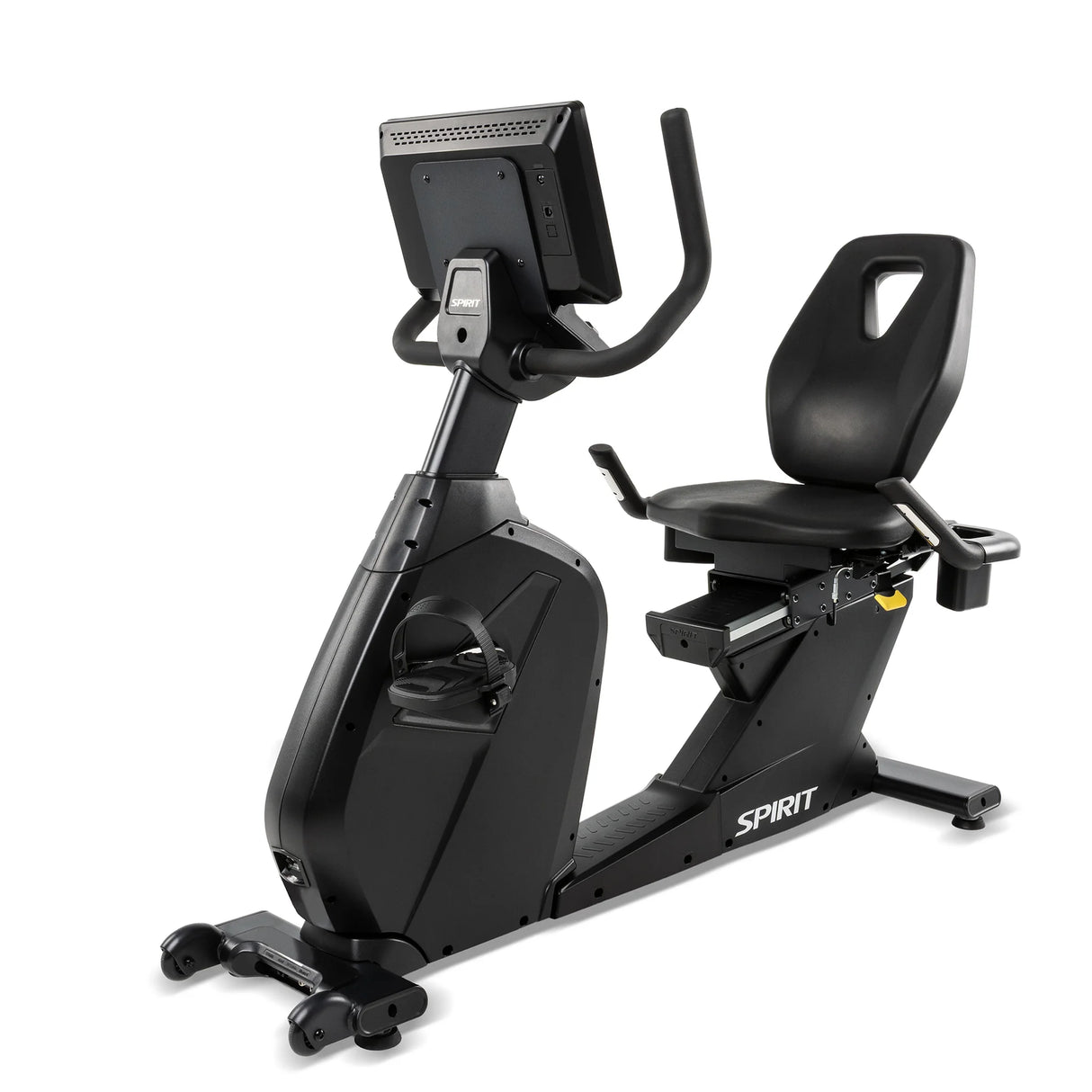 Rear three-quarter view of the Spirit Fitness CR1000ENT Recumbent Bike featuring the back of the touchscreen console, the backrest's molded carry handle, a foot pedal with strap in the foreground, and the Spirit logo on the base rail.