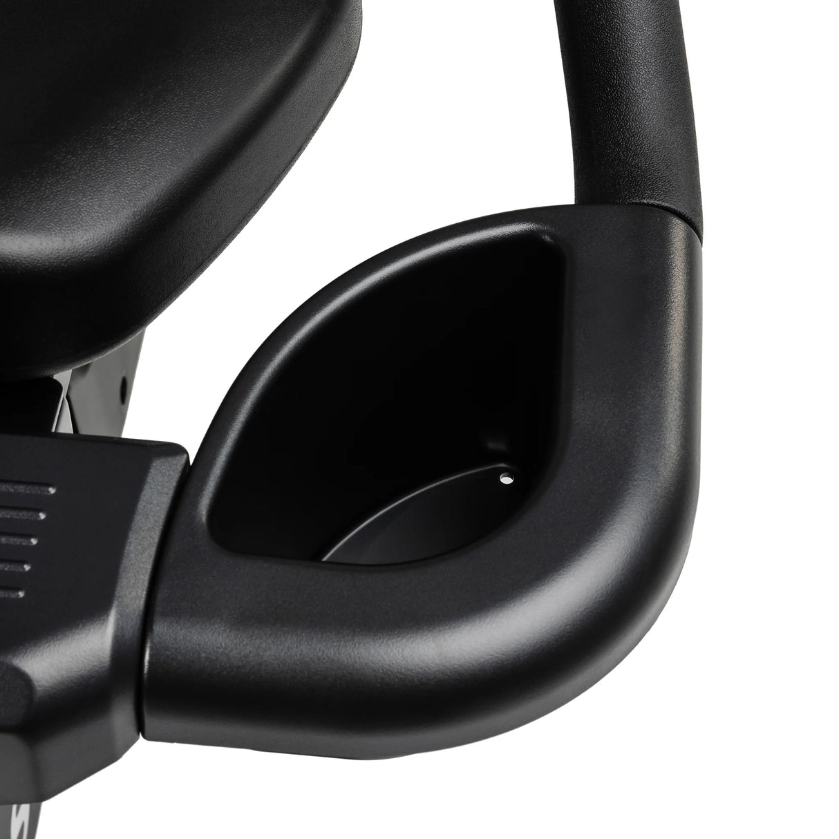 Close-up of a black plastic cup holder attached to the armrest of the Spirit Fitness CR900 Recumbent Bike by Spirit Fitness, with part of the seat visible in the upper left corner.