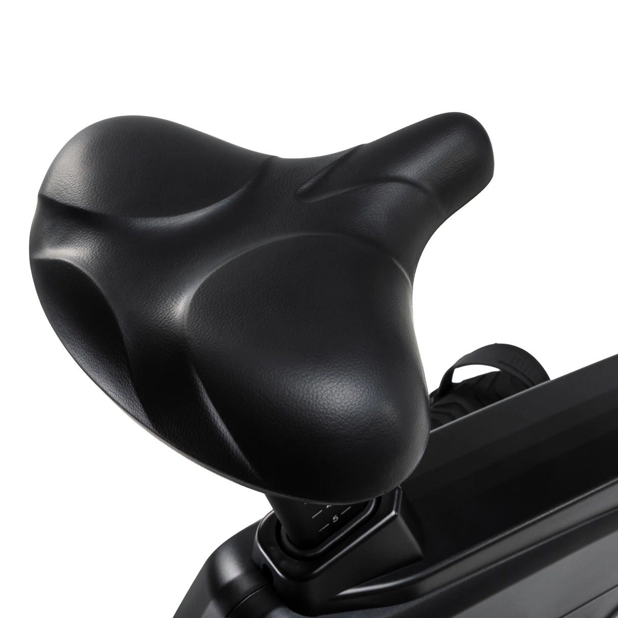 Close-up of the wide, contoured saddle on the Spirit Fitness CU1000ENT Upright Bike, showing the cushioned seat padding and stitching detail.