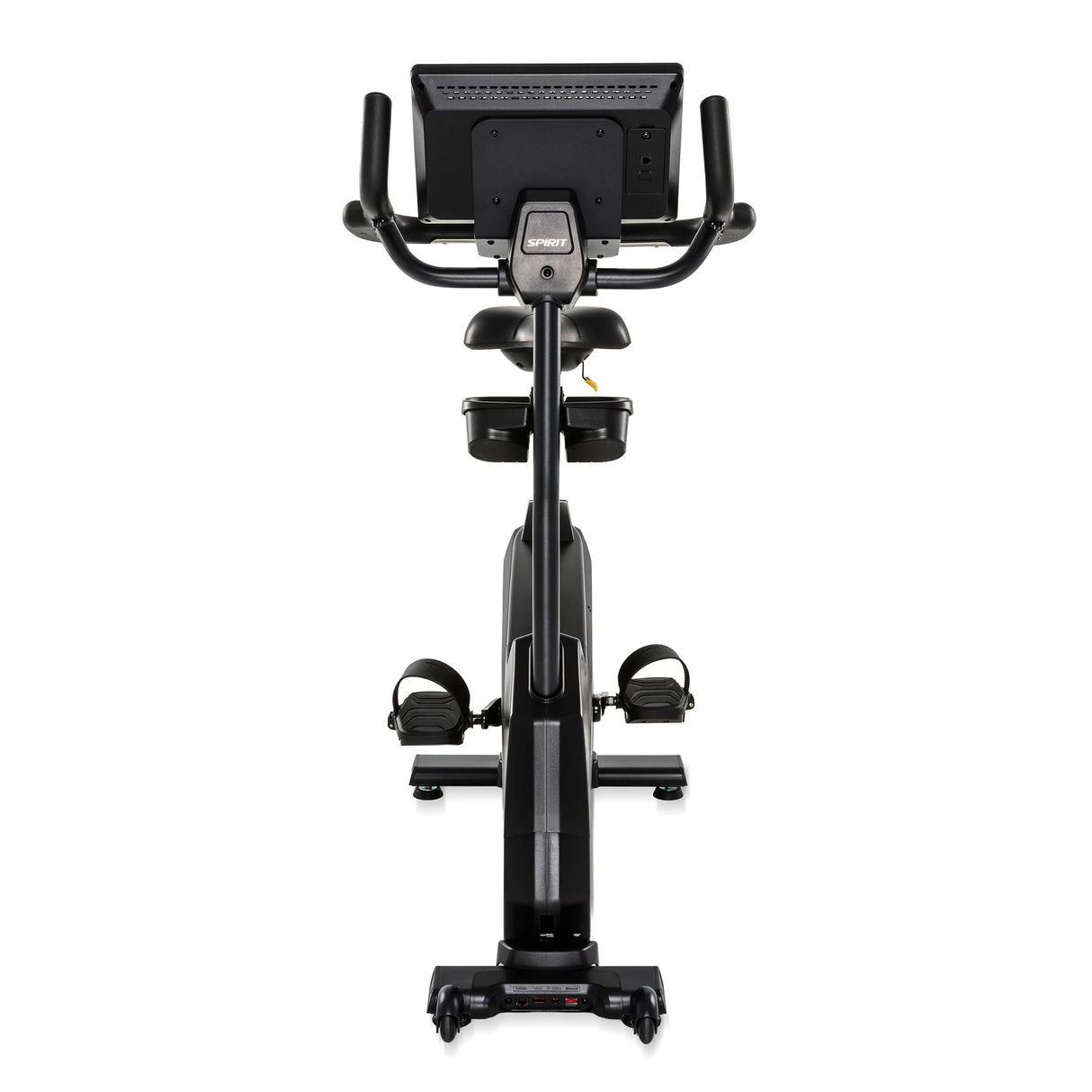 Rear view of the black Spirit Fitness CU1000ENT Upright Bike showing the back of the console, seat with dual accessory/water bottle holders below, pedals with adjustable straps, and the rear base with built-in transport wheels.