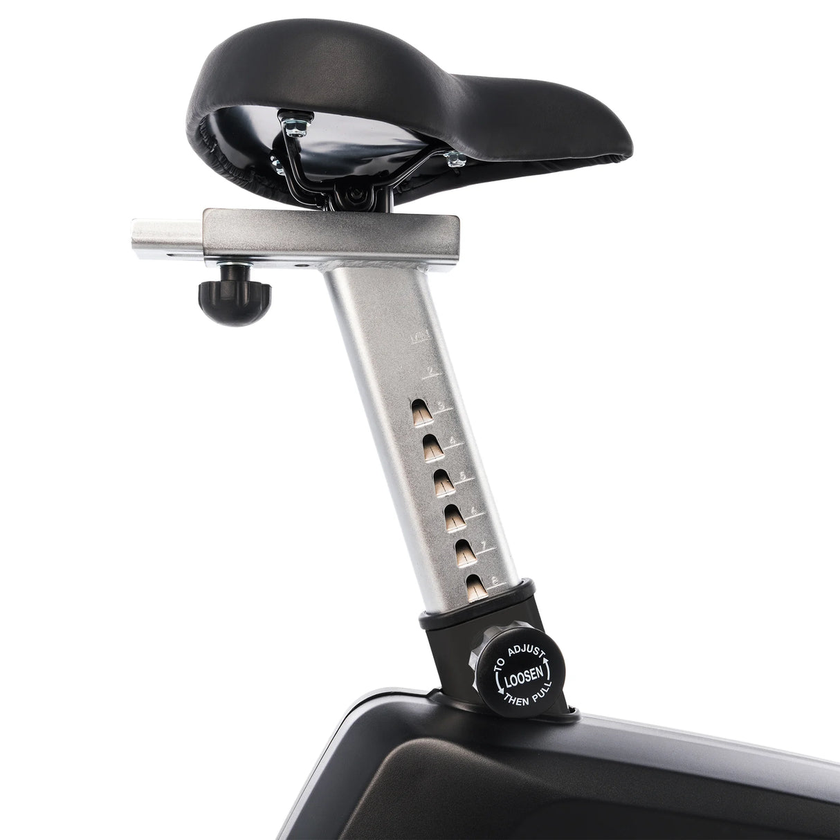 Close-up of the Spirit Fitness CU800 Upright Bike’s adjustable seat post, featuring a black padded saddle, silver numbered post with adjustment holes, and a black knob labeled "To Adjust, Loosen, Then Pull.