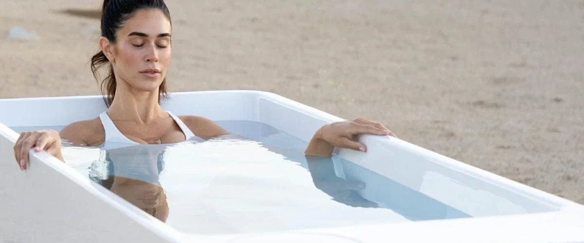 Woman in cold plunge with eyes closed