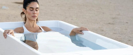 Woman in cold plunge with eyes closed