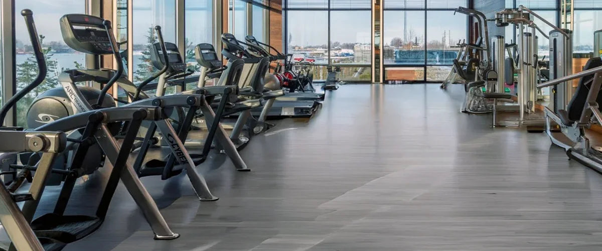 Gray ECORE Moxie flooring in a gym with large glass windows