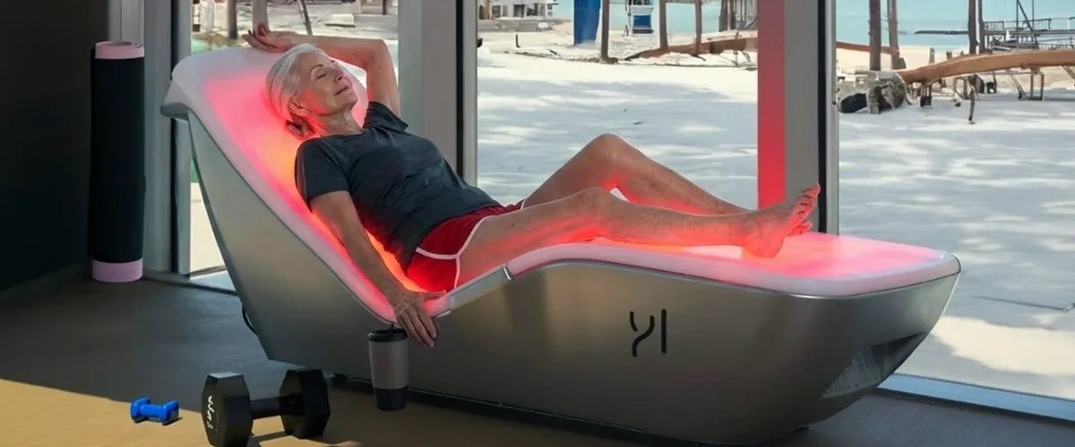 Elderly woman relaxing in a red light therapy lounger