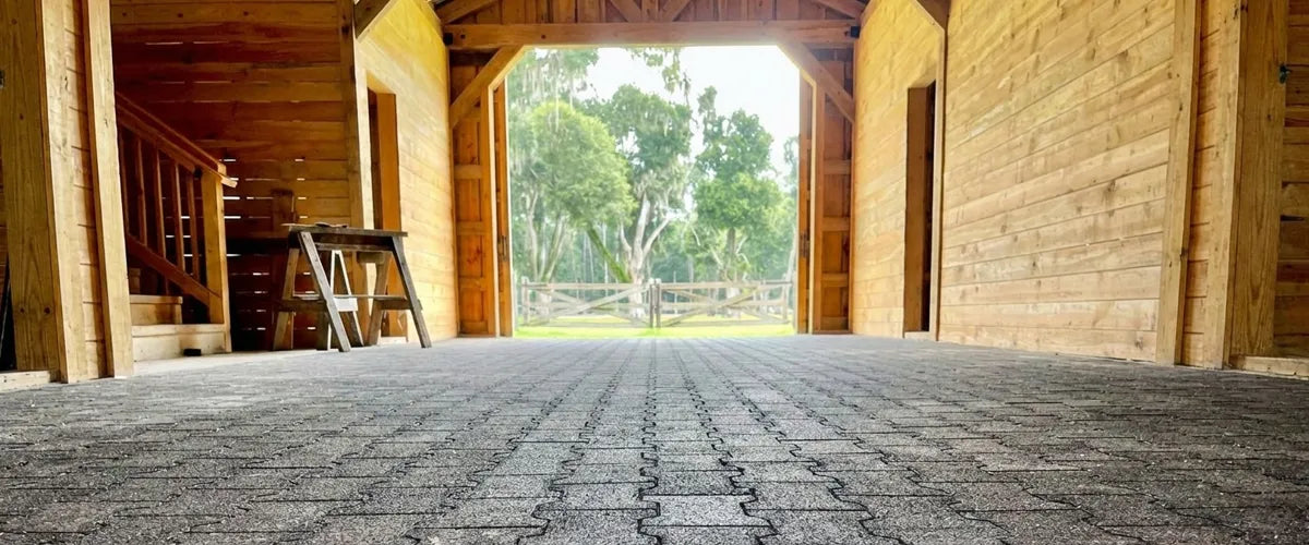 Low angle photo of black rubber pavers in a wooden barn
