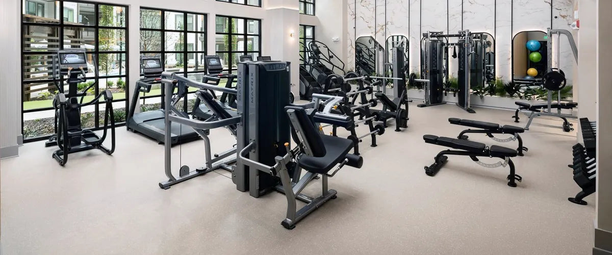 High end apartment gym with light gray rubber floor