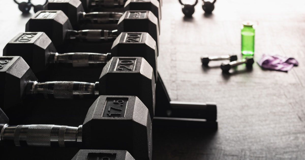 black and gray dumbbells on floor