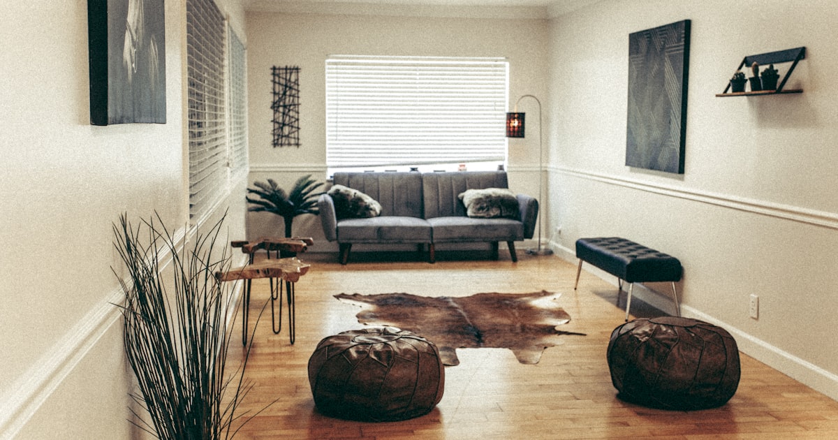 black leather sofa near brown wooden coffee table