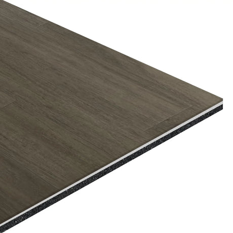 A close-up of the ECORE Athletic Balanced Motivate Laminate Roll - 7mm Class 1 Flooring shows its rectangular, layered design with a dark wood grain top and black core layers against a white background.