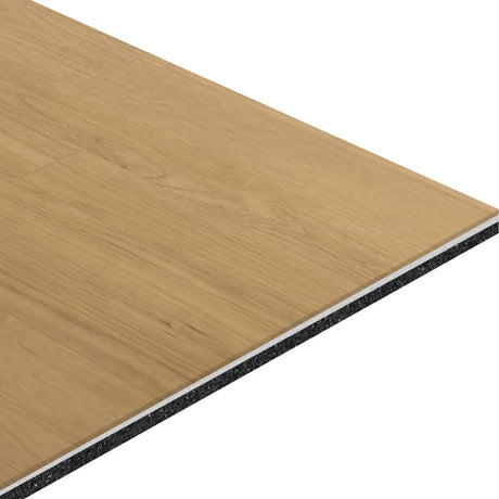 A close-up of ECORE Baller Motivate Laminate Roll—7mm Class 1 Flooring by ECORE Athletic, showing its rectangular layered structure with a light wood grain surface and a dark, dense backing.