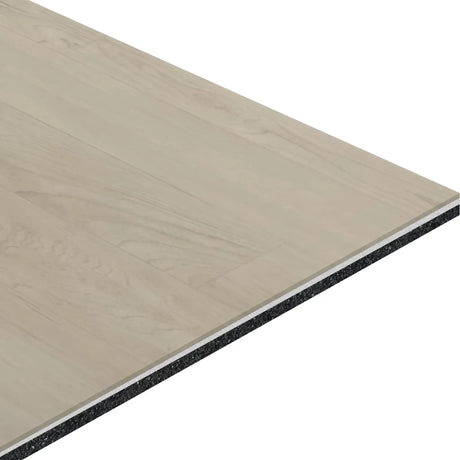 A close-up of ECORE Baller Motivate Laminate Roll - 7mm Class 1 Flooring by ECORE Athletic, featuring a smooth light wood-grain surface and a dark, textured underlayer showcasing its layered structure.