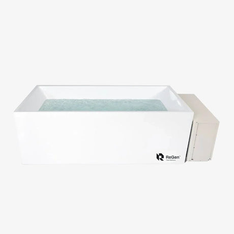 A rectangular cold plunge filled with water with a white exterior and a white external chiller unit on the right side of the plunge
