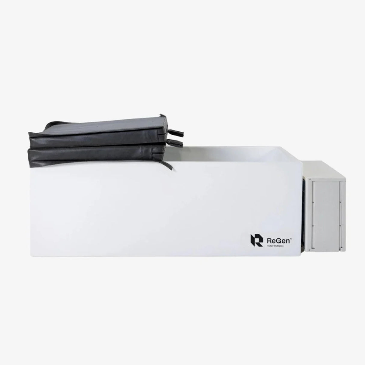 A rectangular cold plunge with a white exterior and a black foldable foam cover on top which is folded in half. There is also a white external chiller unit on the right side of the plunge