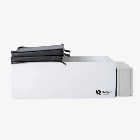 A rectangular cold plunge with a white exterior and a black foldable foam cover on top which is folded in half. There is also a white external chiller unit on the right side of the plunge