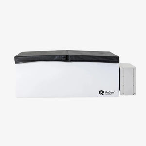 A rectangular cold plunge with a white exterior and a black foldable foam cover on top and a white external chiller unit on the right side of the plunge